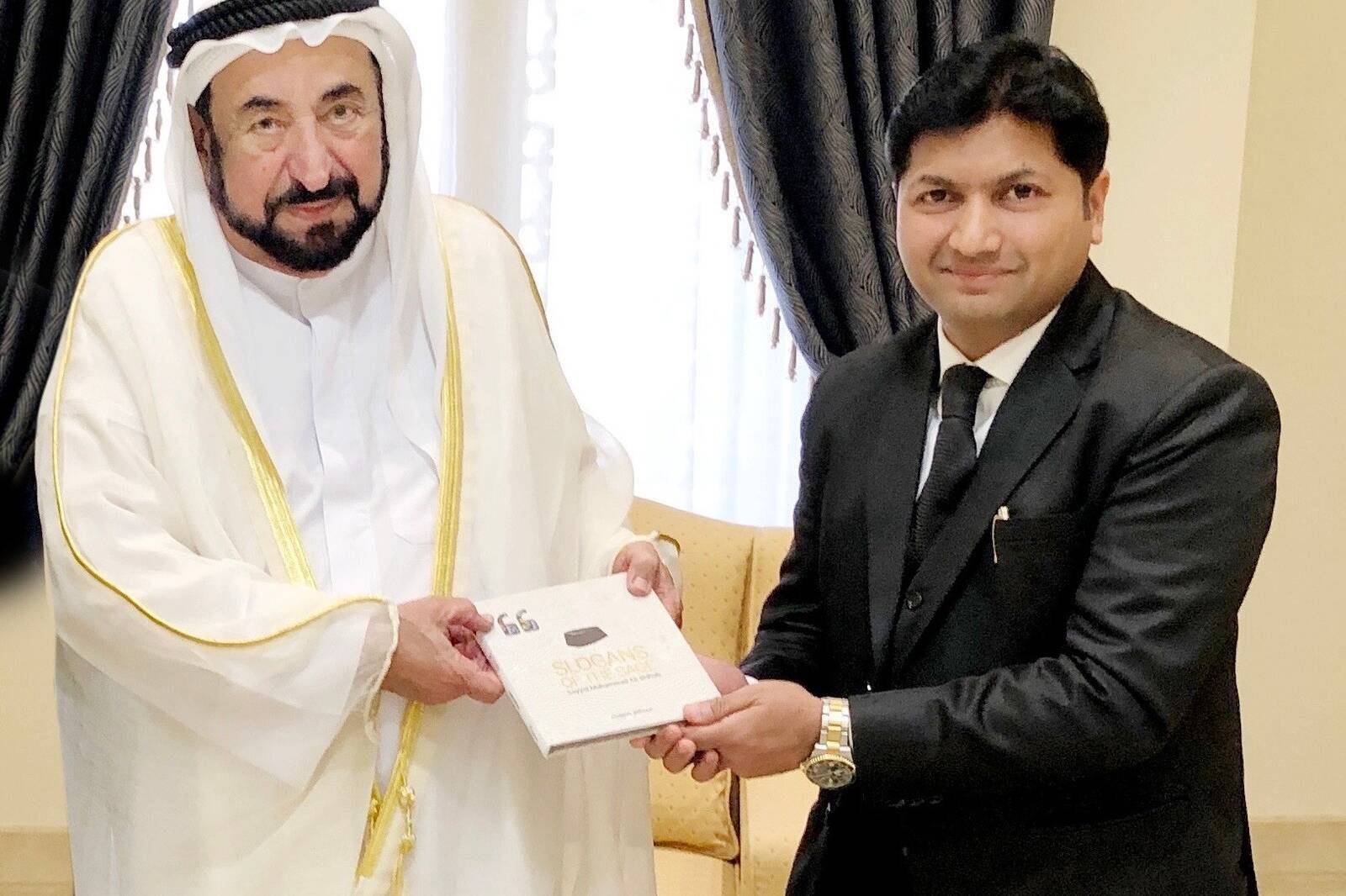 Mujeeb Jaihoon presents SLOGANS OF THE SAGE to Dr. Sheikh Sultan, ruler of Sharjah