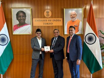 Sadik Ali Shihab Thangal presents Jaihoon's book, Slogans of the Sage, to Sibi George, Indian ambassador to Japan. Also present was Adv. Haris Beeran, Member of Parliament and lawyer at Indian Supreme Court.