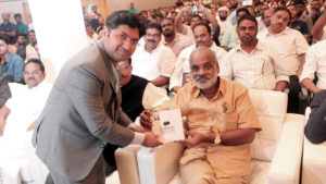 Presenting a copy of the book, Slogans of the Sage, to P. Surendran, award-winning Malayalam writer